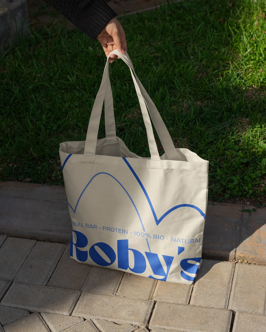 Tote bag crème avec le logotype Roby's en bleu et un motif d'arches